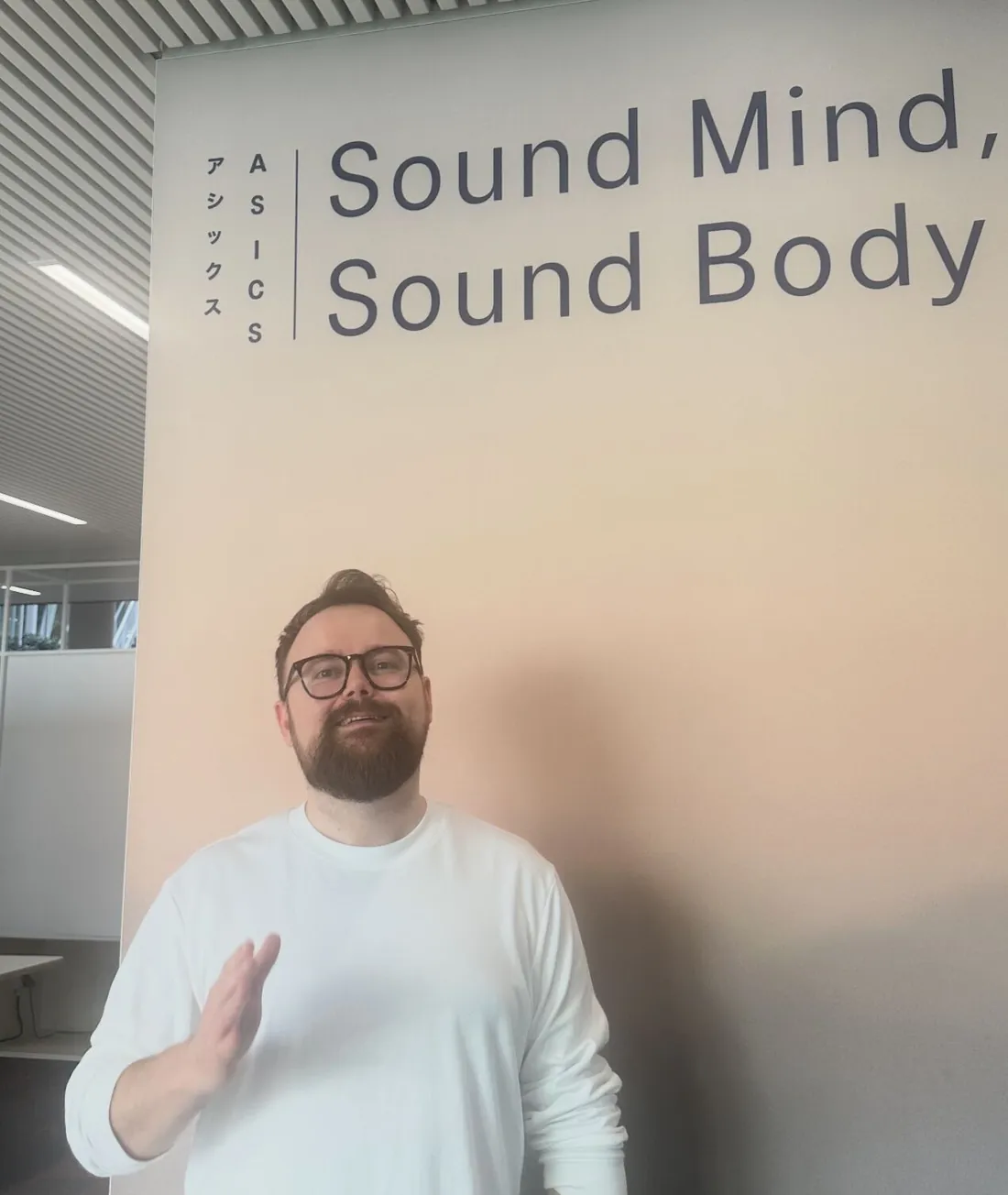Ben under the ASICS 'Sound Mind, Sound Body' sign