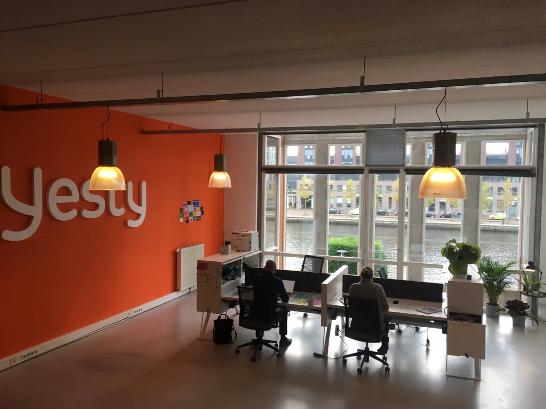 A startup office in Amsterdam with an orange wall